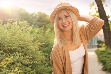 Photo of Portrait of beautiful woman in straw hat outdoors on sunny day