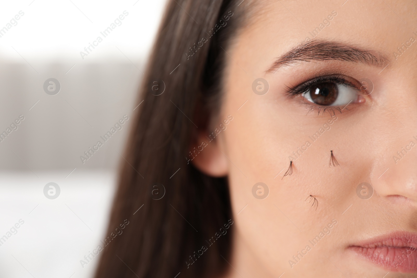 Photo of Beautiful woman with fallen eyelashes on blurred background, closeup. Space for text