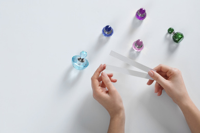 Photo of Woman with perfume testing stripes on white background, top view