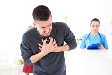 Young man having heart attack in clinic