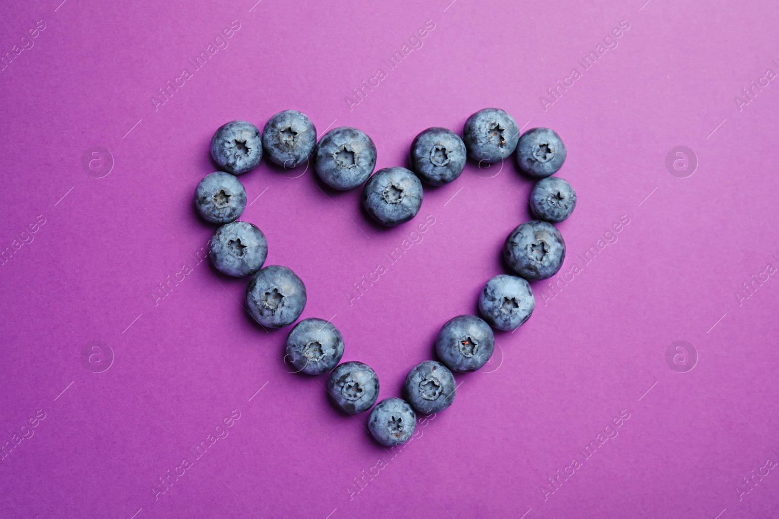 Photo of Flat lay composition with tasty blueberry on color background