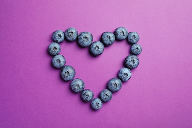 Photo of Flat lay composition with tasty blueberry on color background