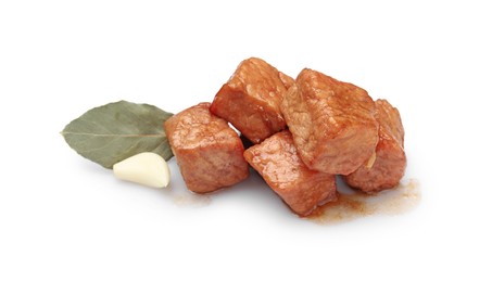Pieces of delicious cooked beef, garlic and bay leaf isolated on white. Tasty goulash