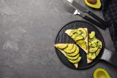 Photo of Flat lay composition with avocado toasts on grey table. Space for text