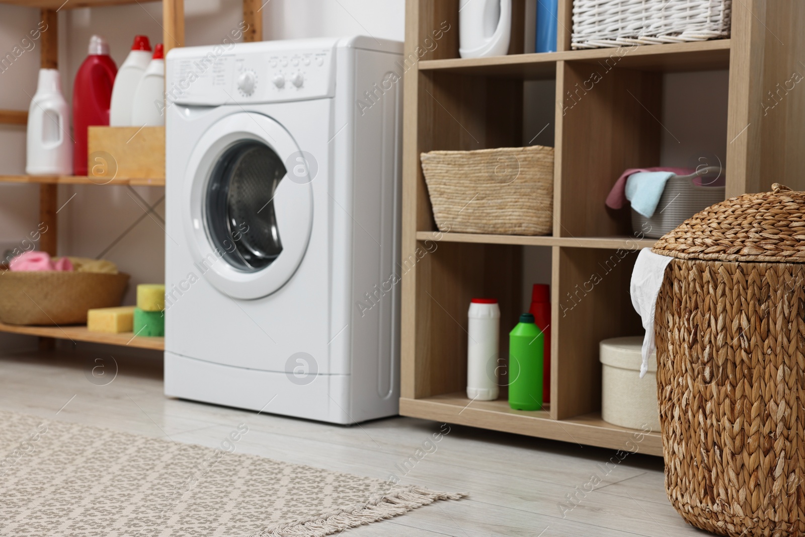 Photo of Laundry room interior with washing machine and furniture