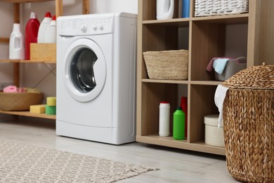 Photo of Laundry room interior with washing machine and furniture