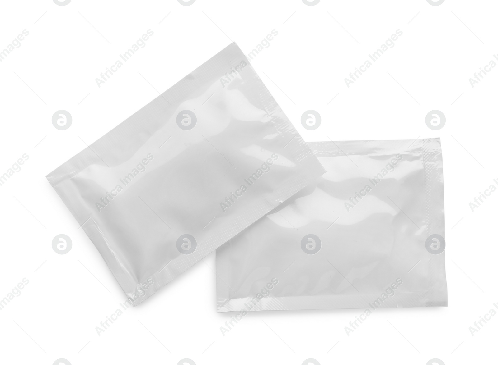 Photo of Blank sachets with wet wipes on white background, top view. Space for design