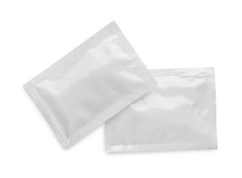 Blank sachets with wet wipes on white background, top view. Space for design