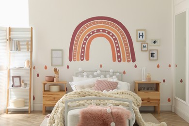 Photo of Stylish child's room interior with comfortable bed