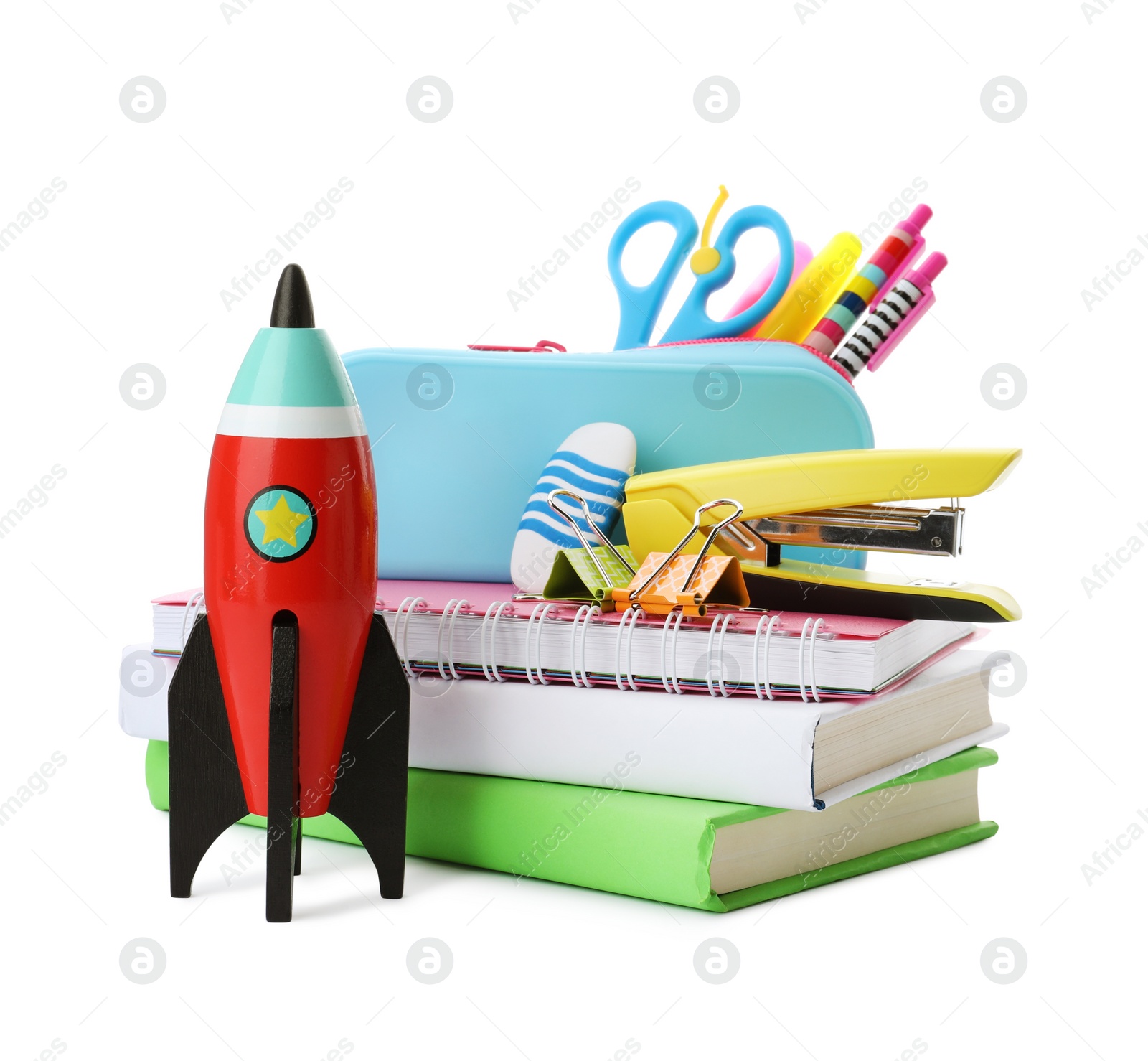 Photo of Bright toy rocket and school supplies on white background