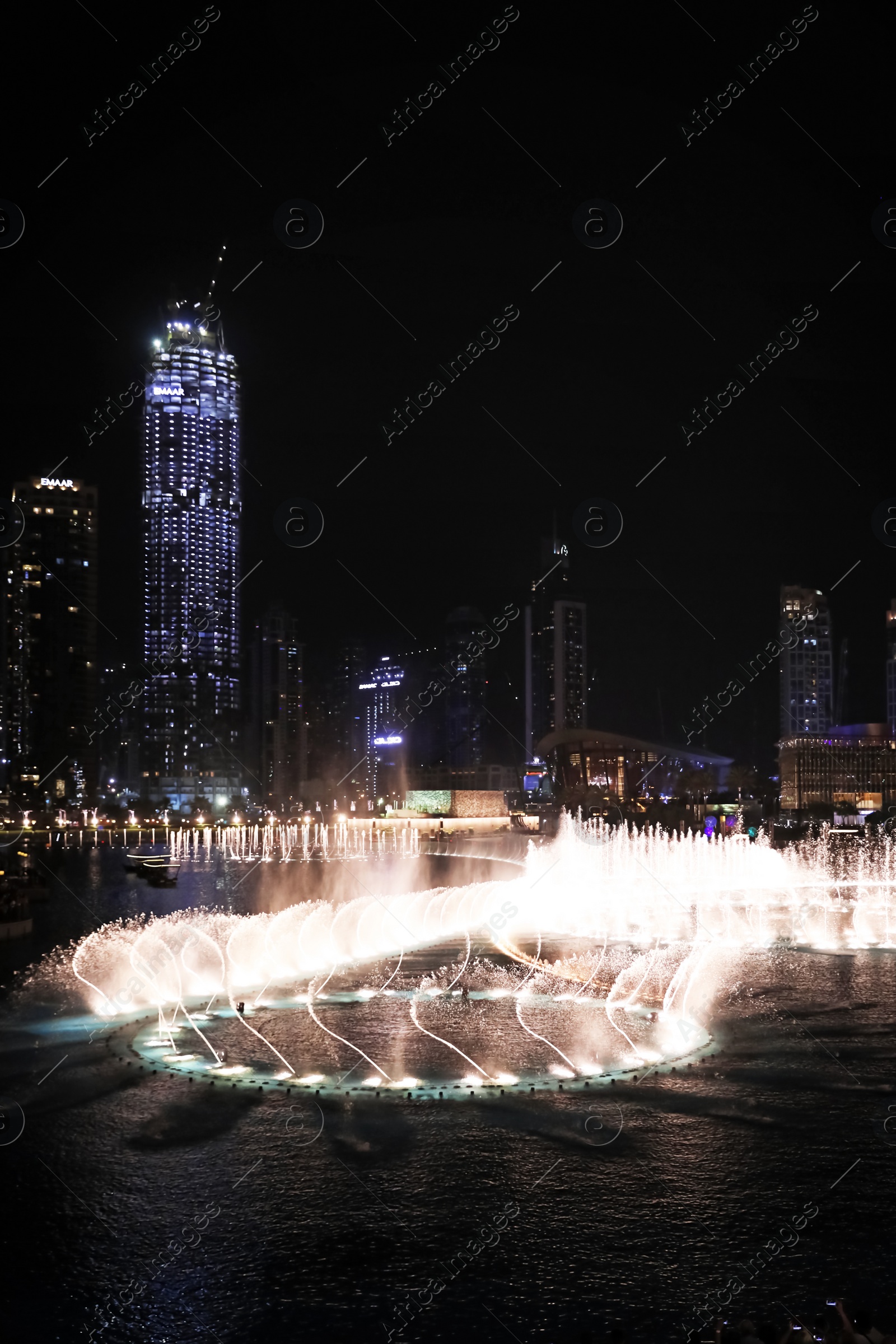 Photo of DUBAI, UNITED ARAB EMIRATES - NOVEMBER 04, 2018: Famous dancing fountain show on Burj Khalifa lake at night