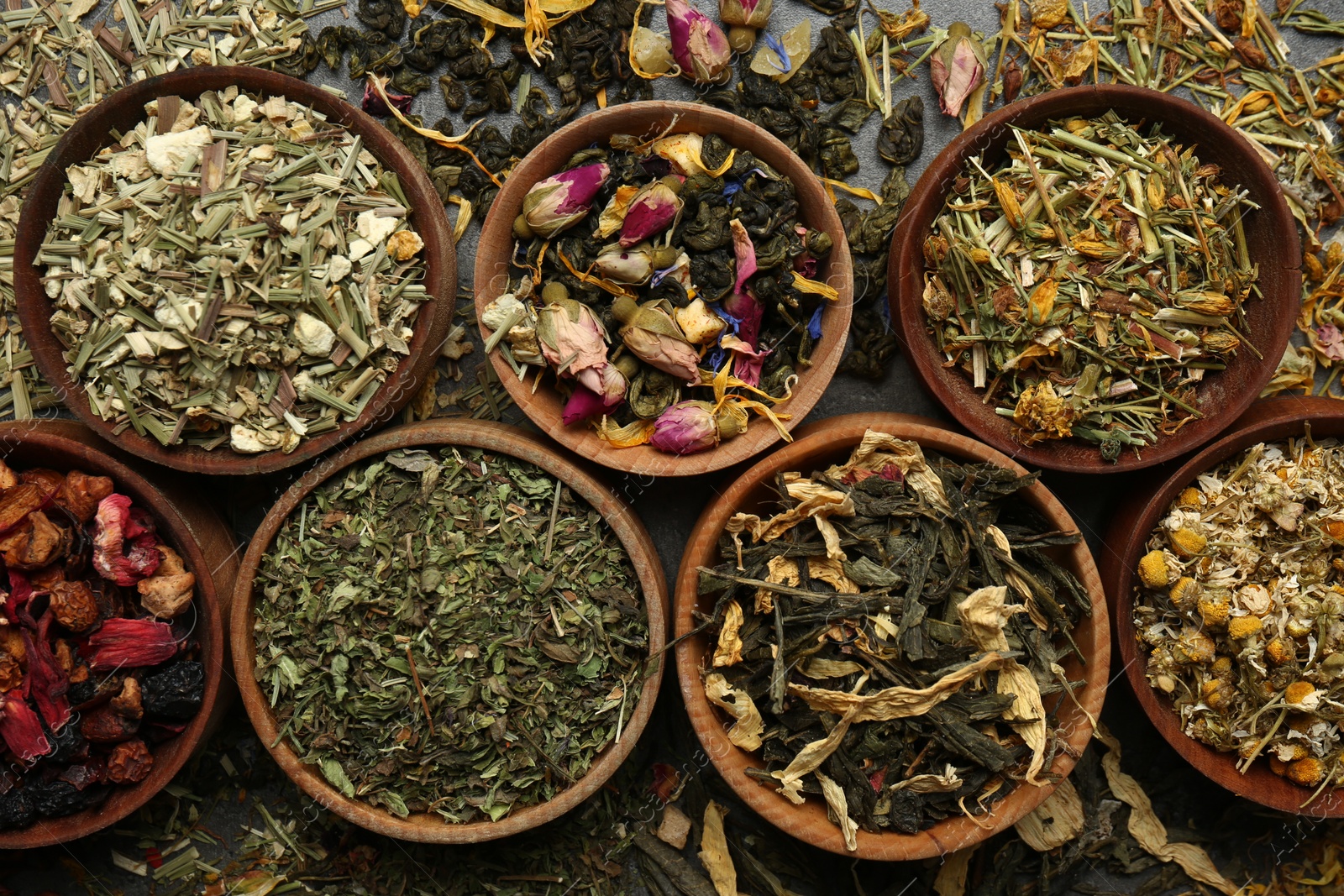 Photo of Flat lay composition with different dry teas on table