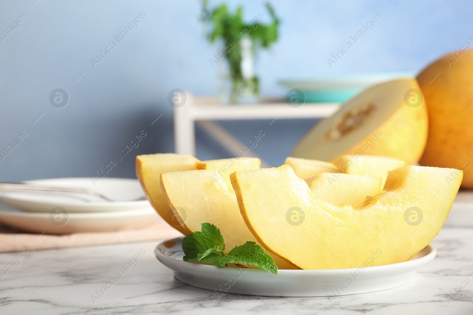 Photo of Plate with fresh delicious melon slices on table