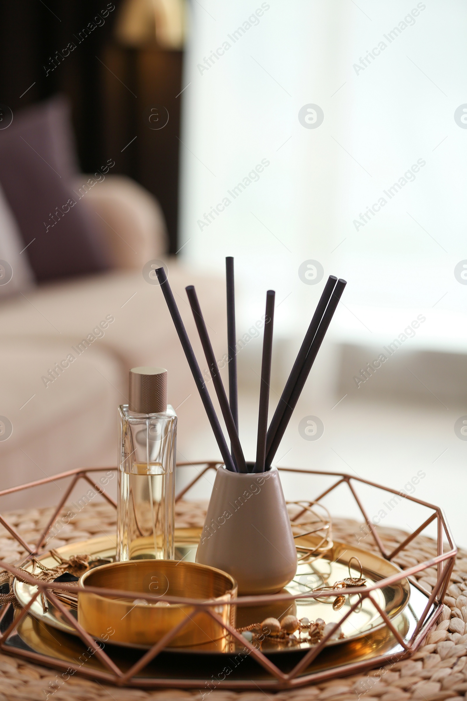 Photo of Composition with stylish accessories and interior elements on wicker pouf indoors