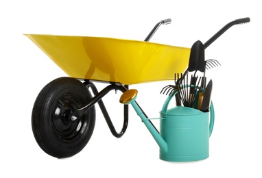 Photo of Wheelbarrow with gardening tools isolated on white