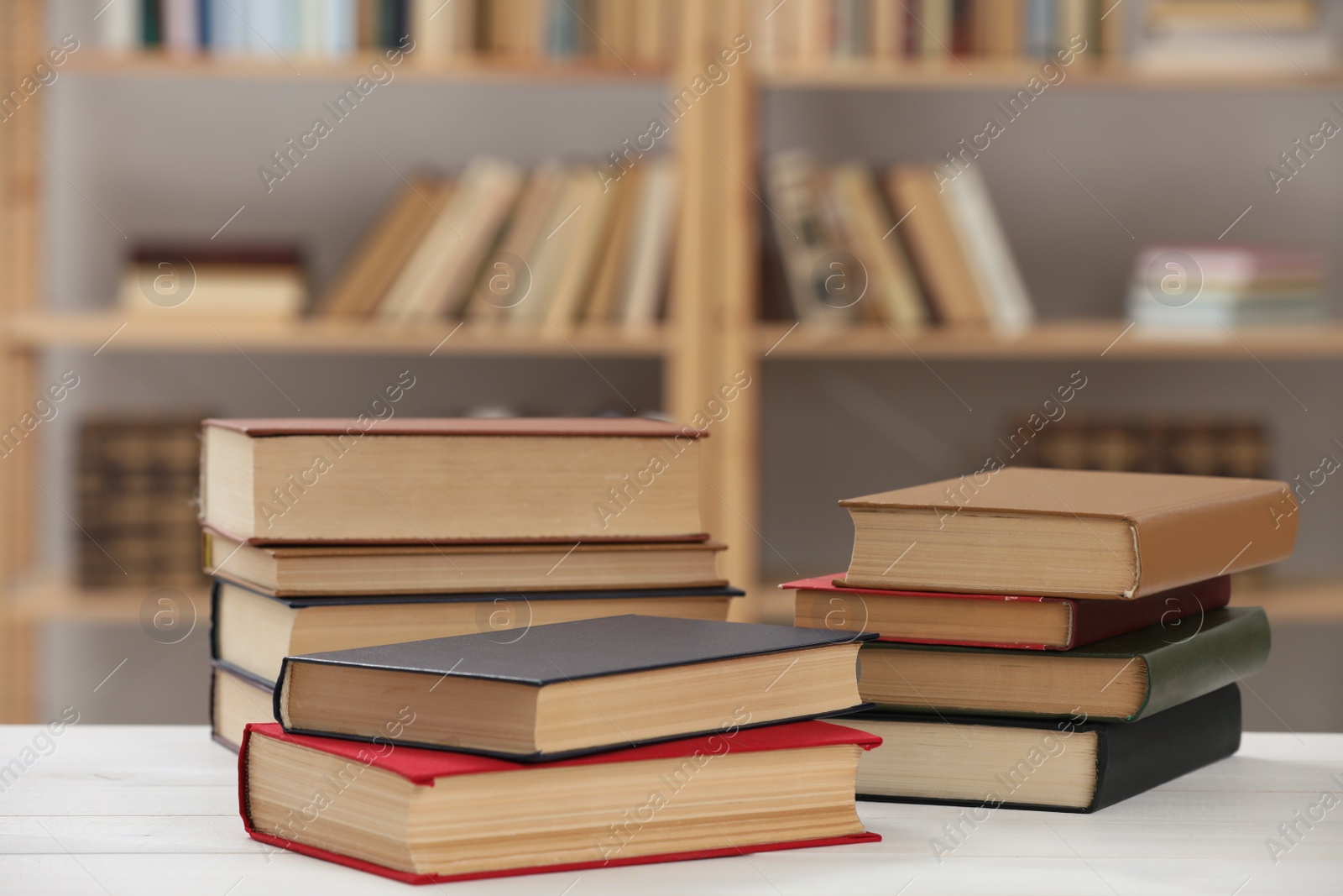 Photo of Many books on white table in library