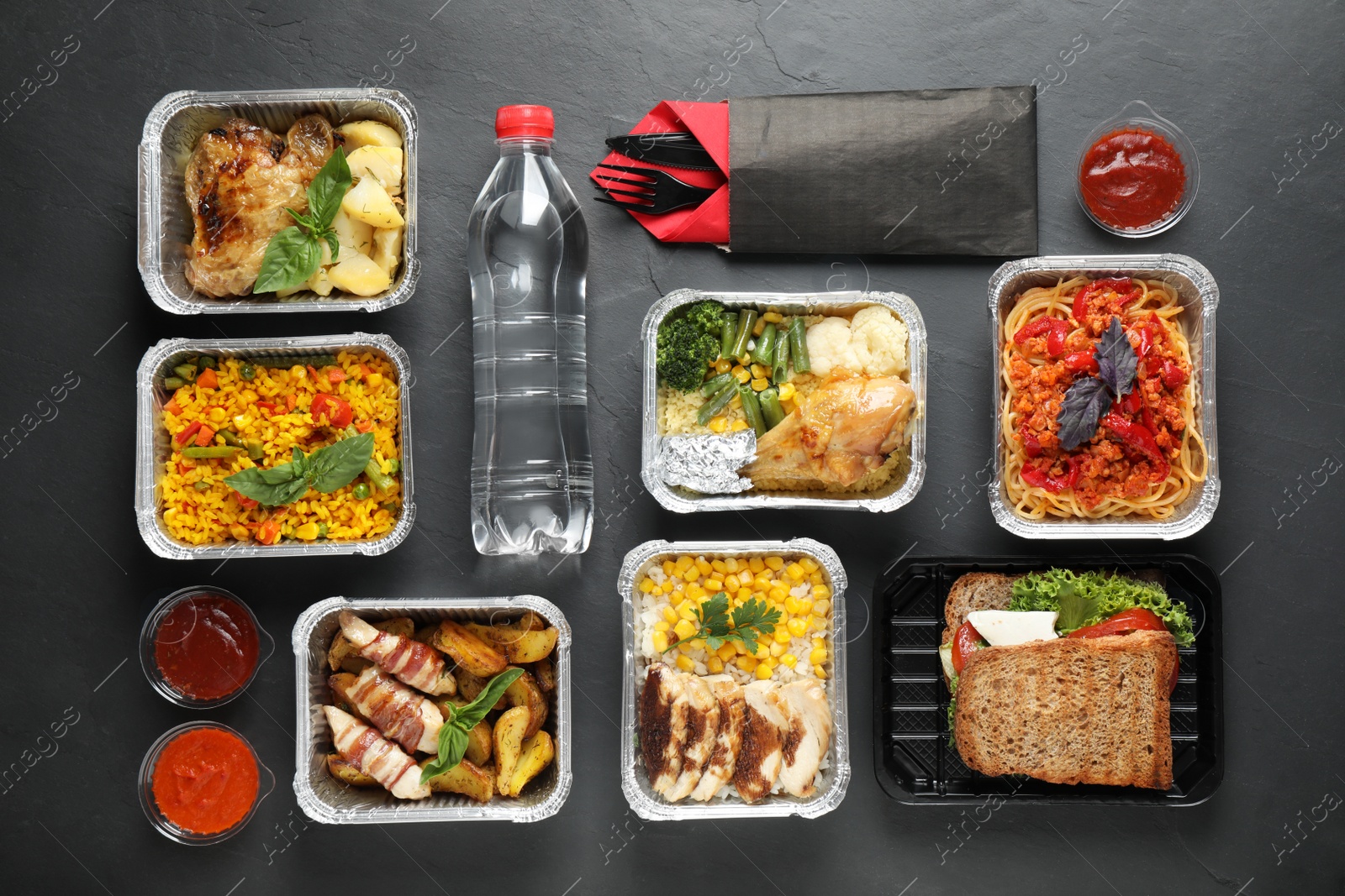 Photo of Lunchboxes on grey table, flat lay. Healthy food delivery