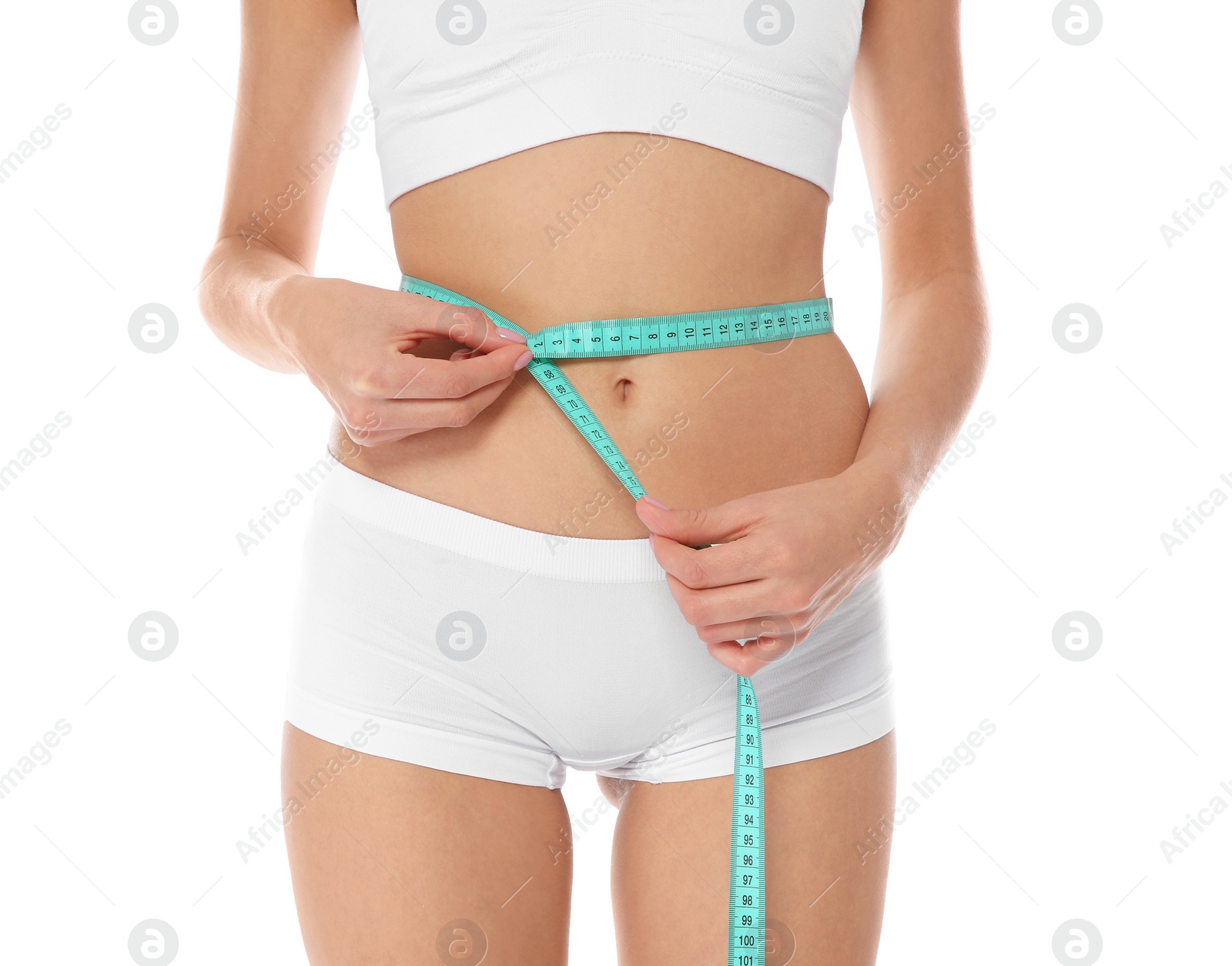Photo of Slim woman measuring her waist on white background, closeup. Weight loss
