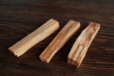 Palo santo sticks on wooden table, closeup