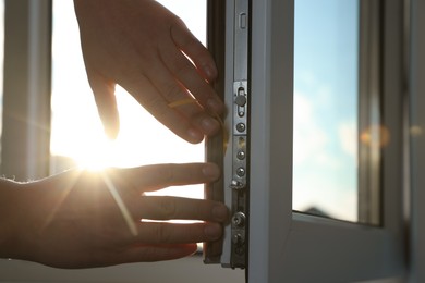 Photo of Construction worker putting sealing foam tape on window, closeup