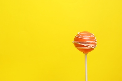 Bright delicious cake pop on color background. Space for text