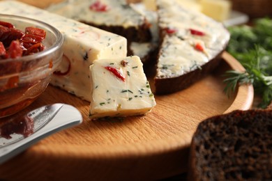 Photo of Tasty butter with dill, chili pepper and rye bread on table, closeup