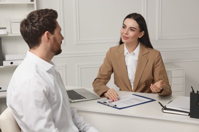 Human resources manager conducting job interview with applicant in office