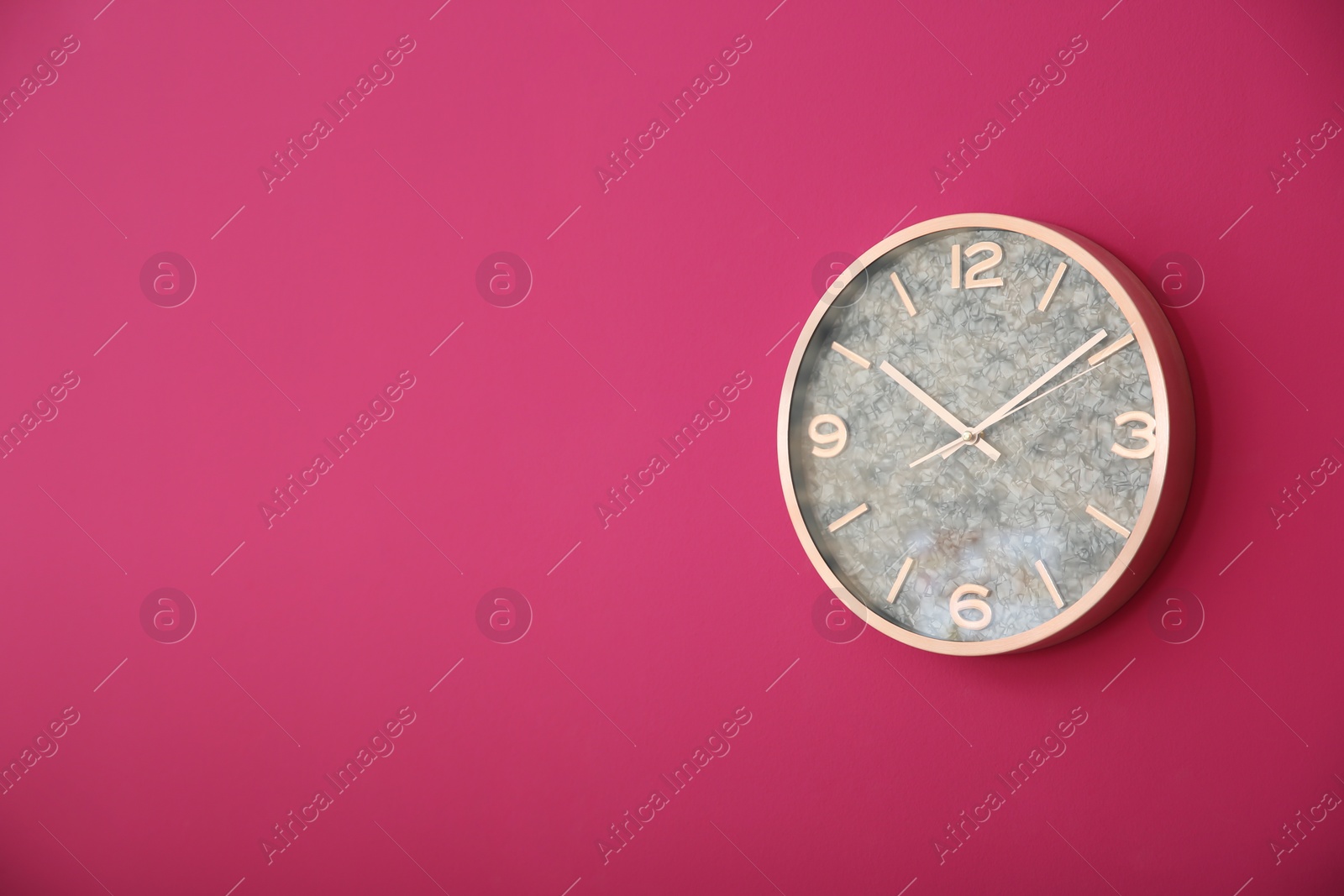 Photo of Stylish clock on color wall. Time concept