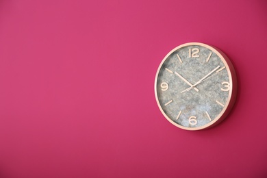 Photo of Stylish clock on color wall. Time concept