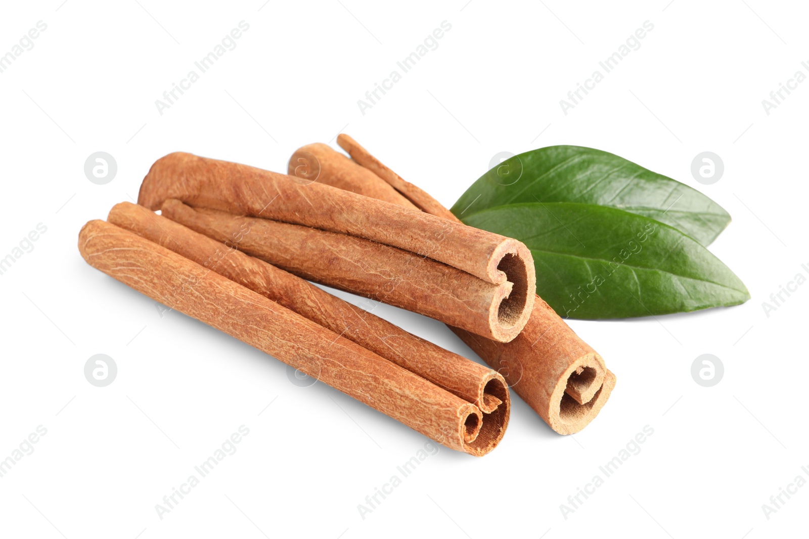 Photo of Cinnamon sticks and green leaves isolated on white