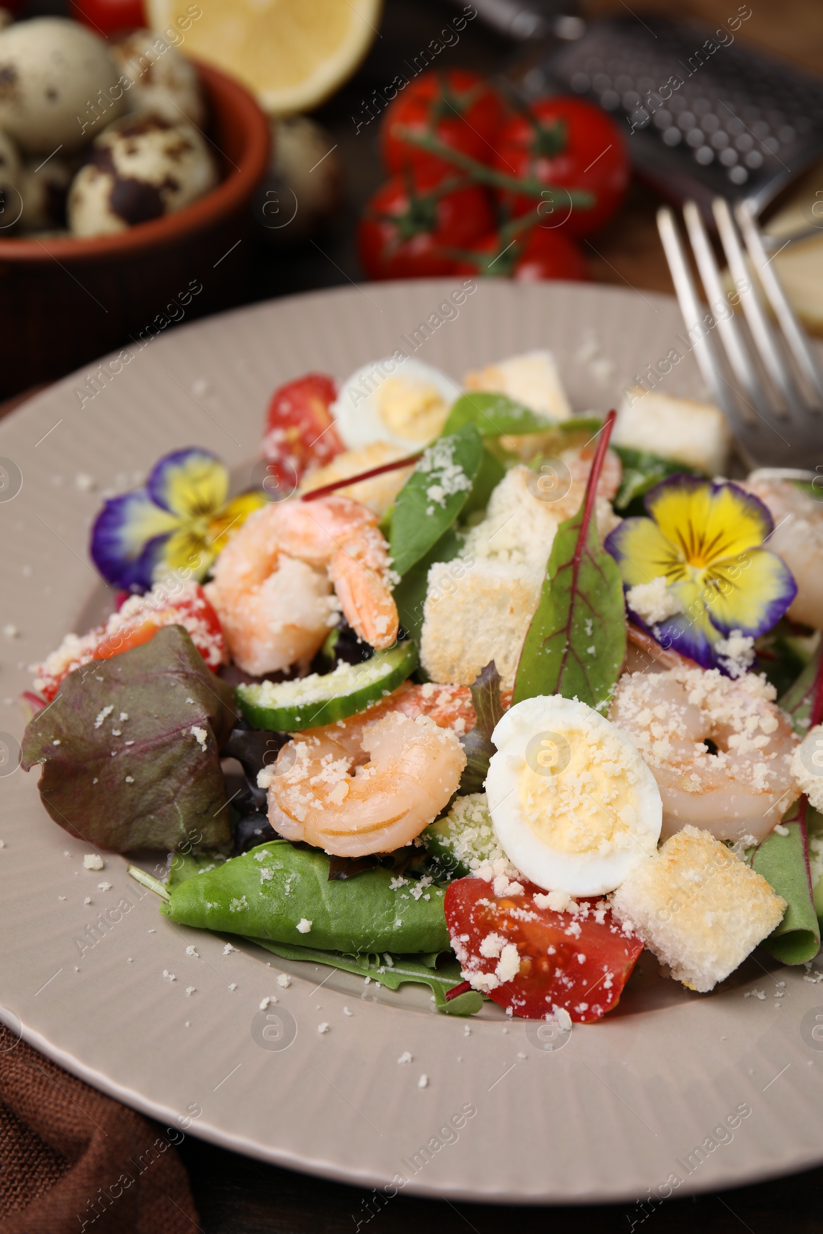 Photo of Delicious Caesar salad with shrimps on table, closeup