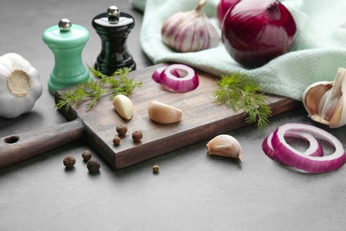 Photo of Composition with onion, garlic and dill on kitchen table