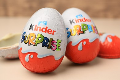 Photo of Slynchev Bryag, Bulgaria - May 25, 2023: Kinder Surprise Eggs on beige background, closeup