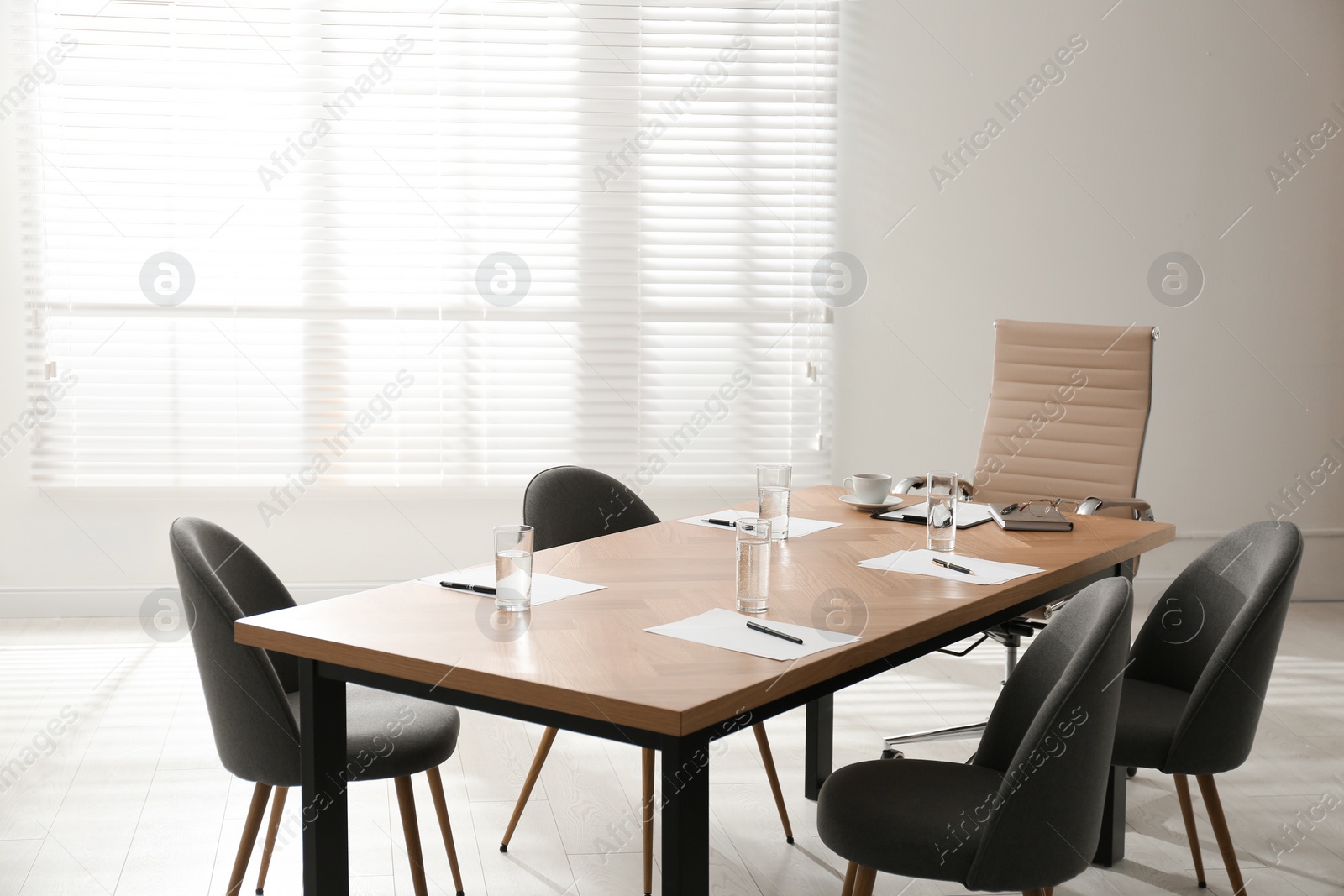 Photo of Simple office interior with large table and chairs