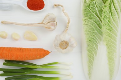 Flat lay composition with fresh Chinese cabbage and ingredients on white wooden table