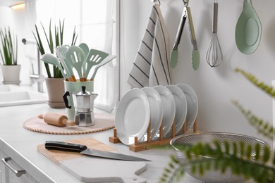 Photo of Set of different utensils and dishes on countertop in kitchen