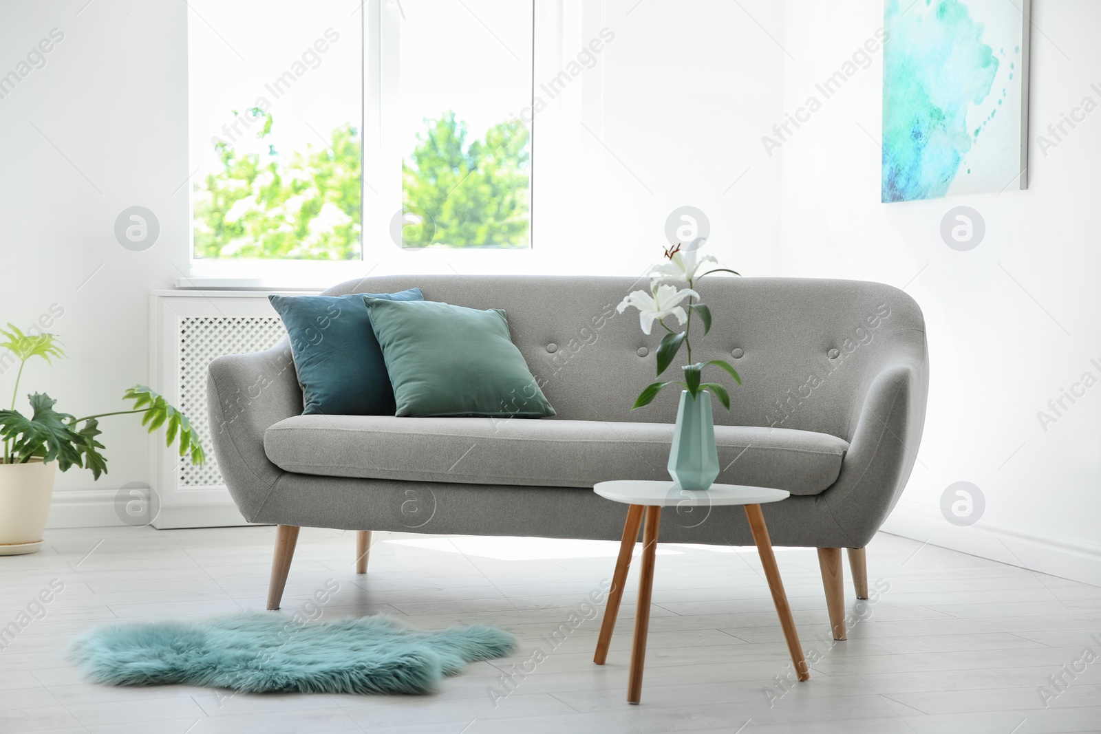 Photo of Stylish living room interior with sofa and mint decor elements