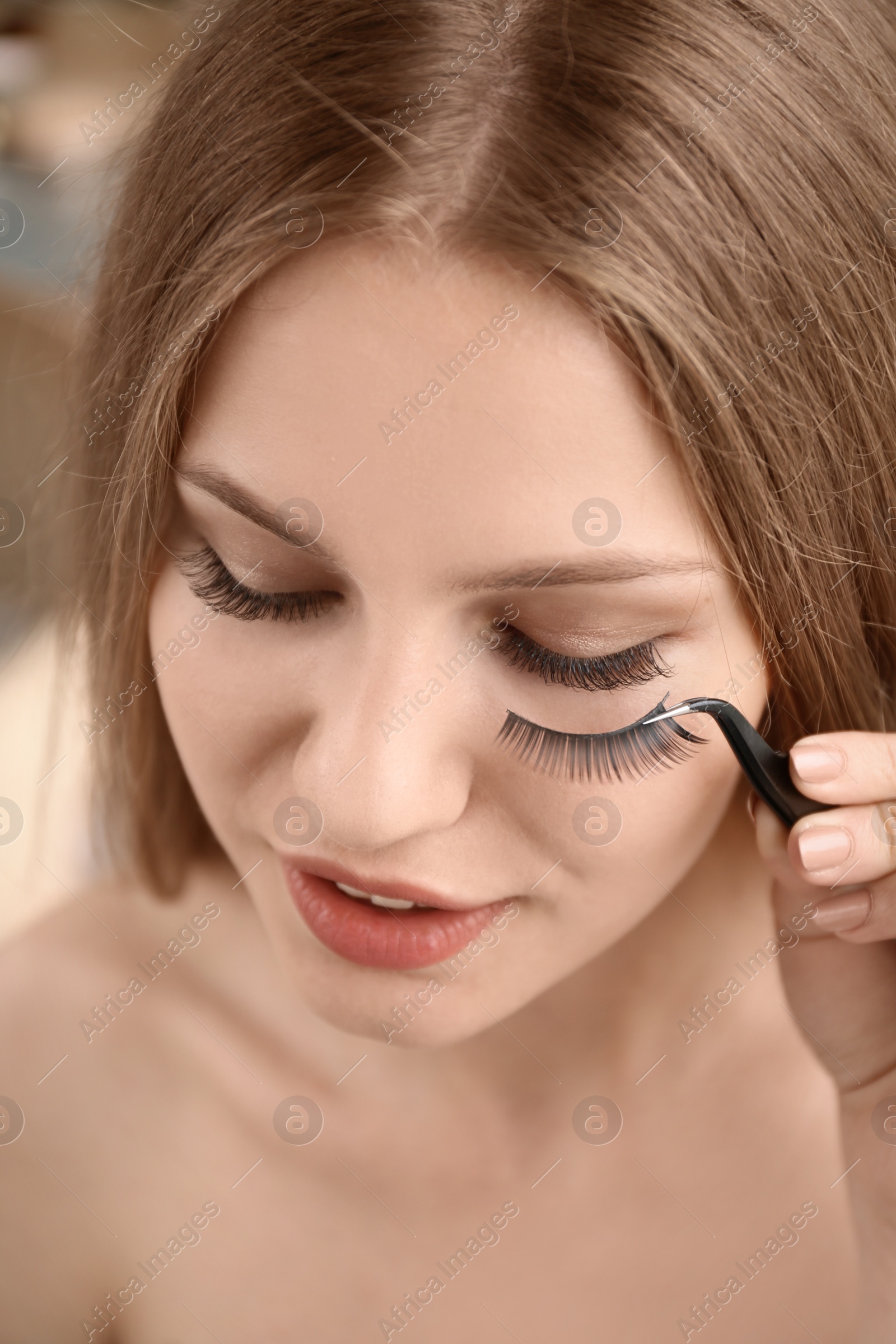Photo of Attractive young woman with false eyelashes, closeup