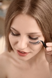Attractive young woman with false eyelashes, closeup