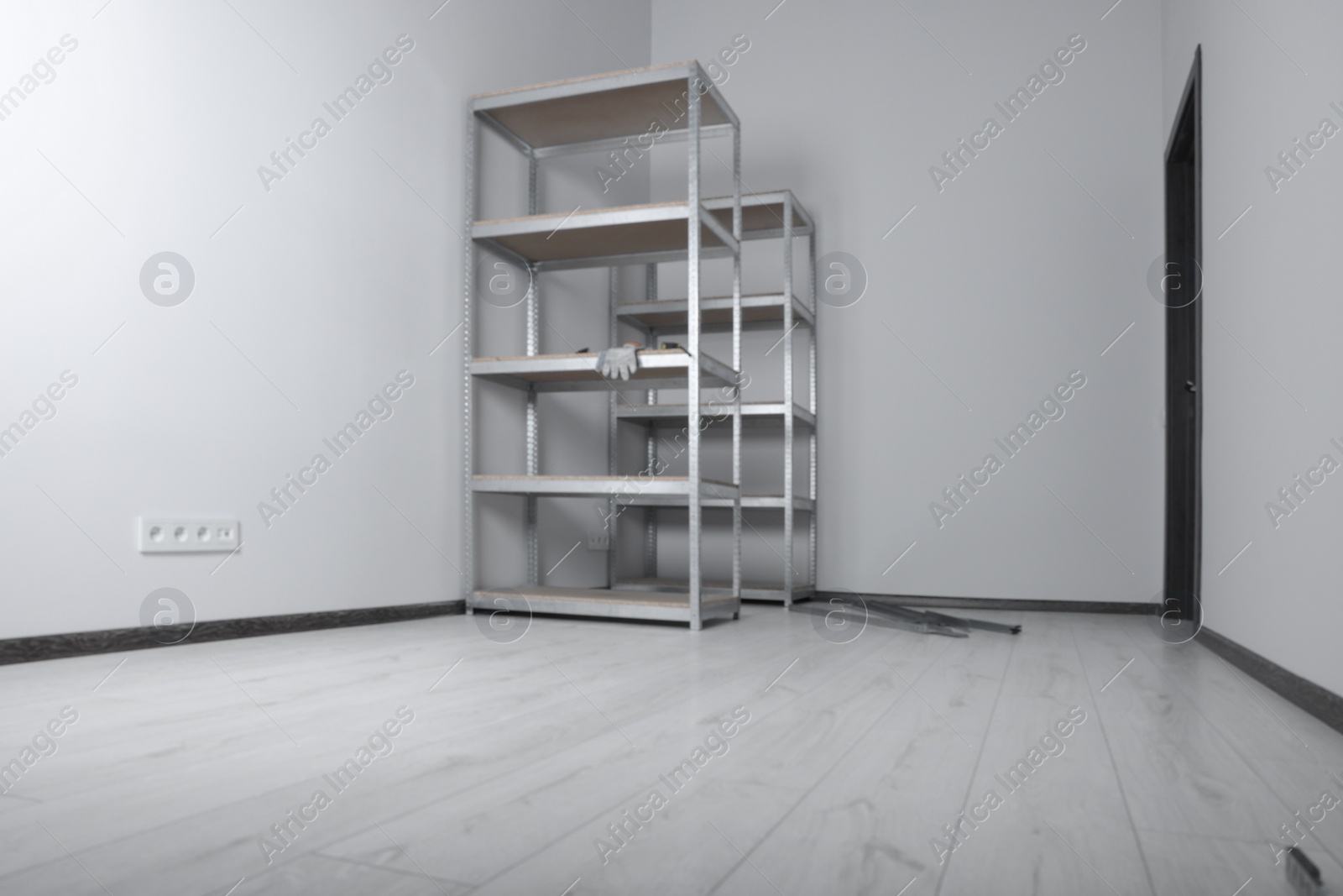 Photo of Office room with white walls and metal storage shelves