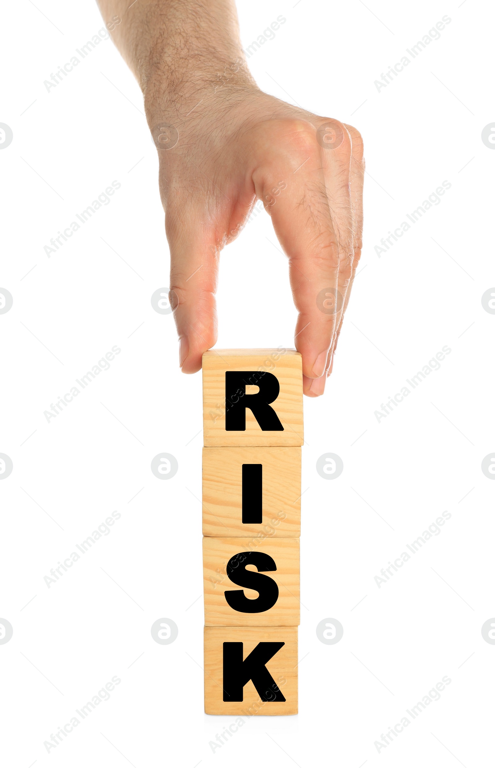 Photo of Man stacking wooden cubes with word Risk on white background, closeup