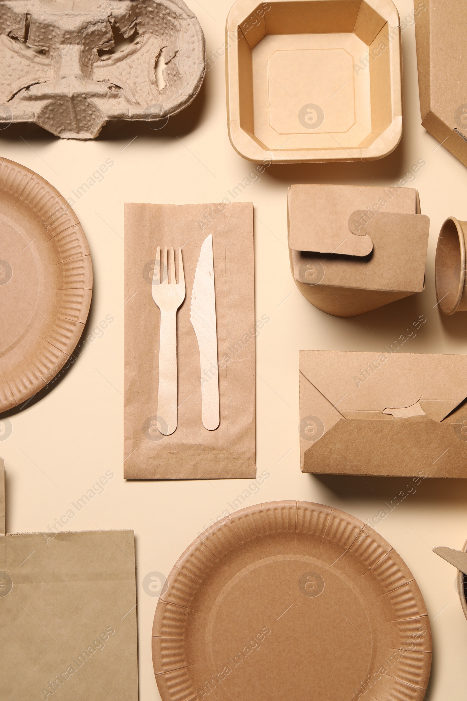 Photo of Flat lay composition with eco friendly food packagings on beige background