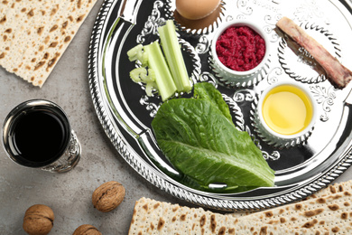 Photo of Flat lay composition with Passover Seder plate (keara) on grey table. Pesah celebration