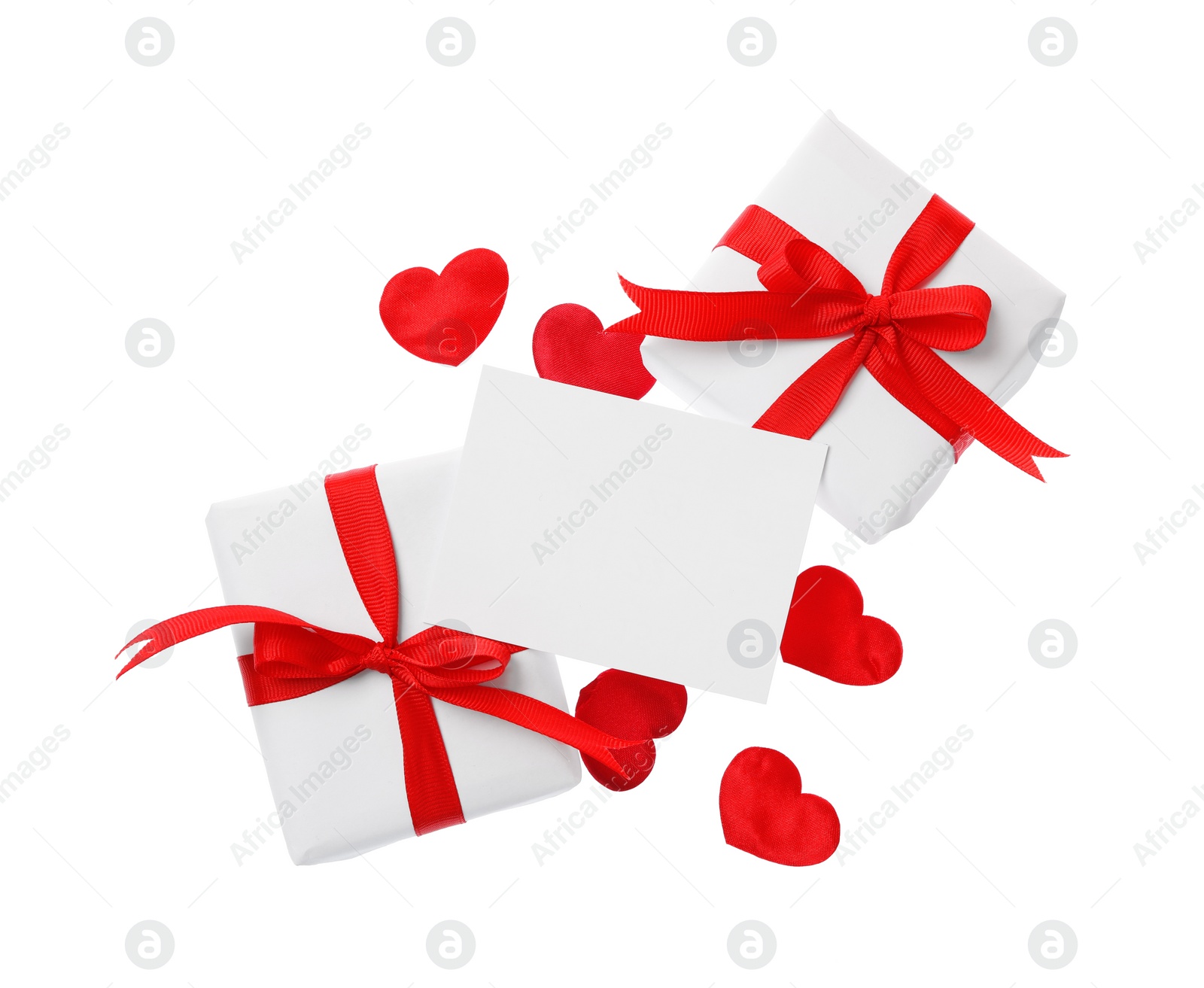 Photo of Blank card, gift boxes and red decorative hearts on white background, top view. Valentine's Day celebration