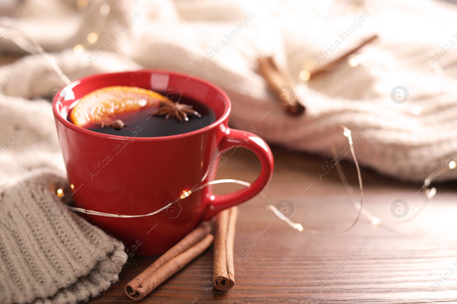 Photo of Beautiful composition with cup of mulled wine on table. Space for text