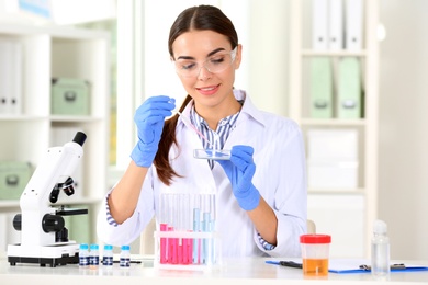 Female scientist working at table in laboratory. Research and analysis