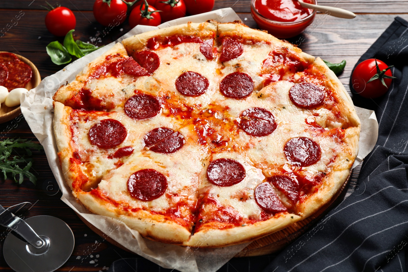 Photo of Hot delicious pepperoni pizza on wooden table