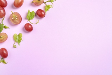 Photo of Flat lay composition with fresh ripe juicy grapes on lilac background, space for text