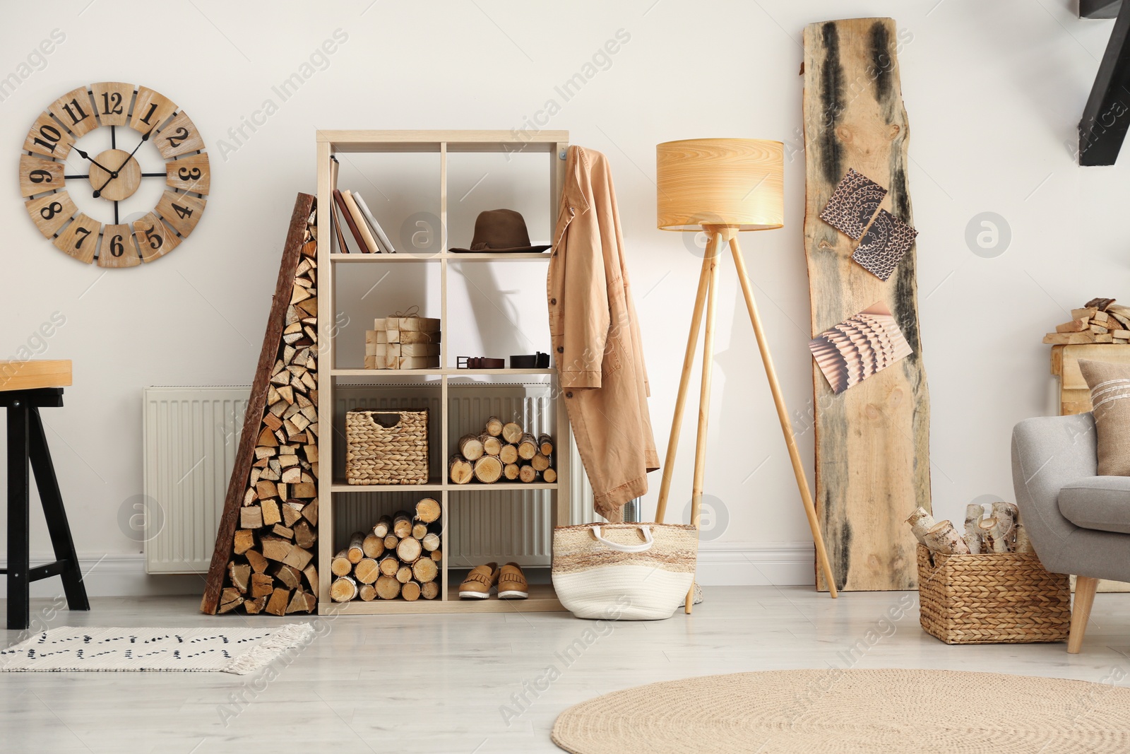 Photo of Stylish room interior with firewood as decorative element