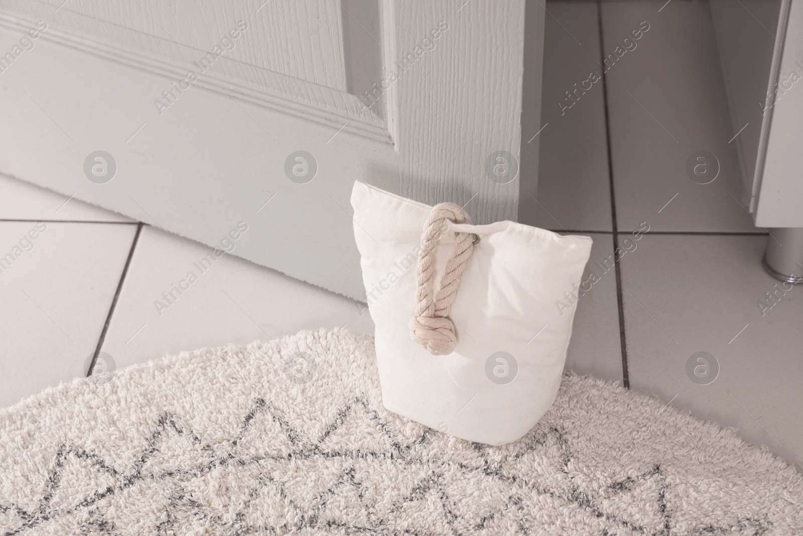 Stuffed bag holding wooden door at home Photo of Stuffed bag holding wooden door at home